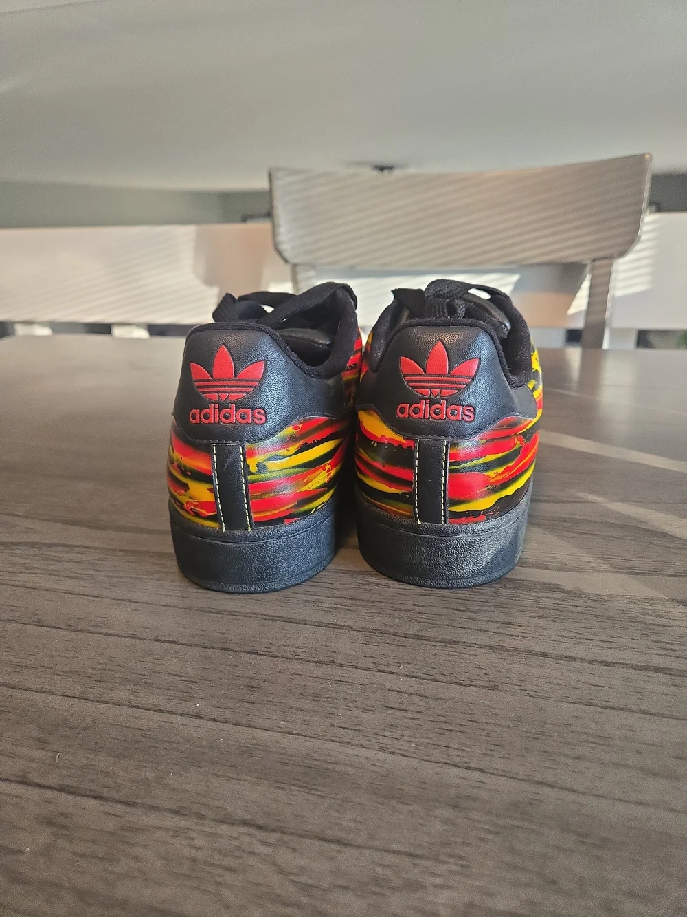 Adidas Black Superstar Sneakers with Red & Yellow Graphic
